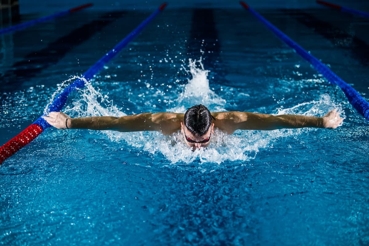 Swimmer doing butterfly stroke in a lap pool